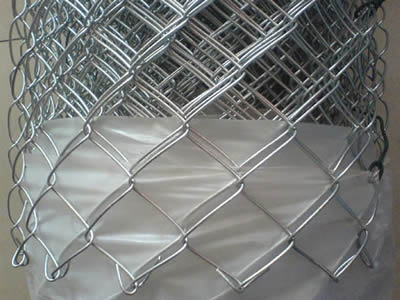 A roll of galvanized chain link fence with plastic film package.