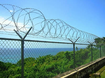 Barbed wire combined with razor wire and chain link fence as a whole is used for river fencing.